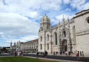 Majestic View Of The Front Exterior Of Mosteiro Dos Jeronimos In Lisbon, Portugal. Wallpaper