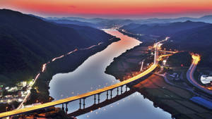 Majestic View Of The Highway Bridge In Busan At Dusk Wallpaper