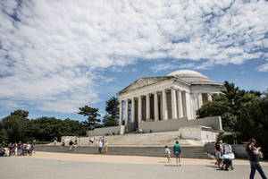 Majestic View Of The Jefferson Memorial Under Cloudy Skies. Wallpaper