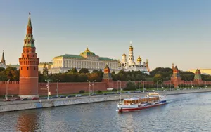 Majestic View Of The Kremlin Palace Amidst A Serene Landscape Wallpaper