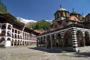 Majestic View Of The Rila Monastery Courtyard In Bulgaria Wallpaper