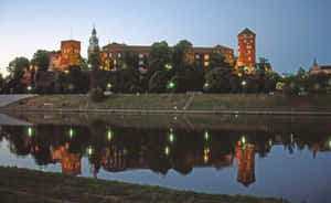 Majestic View Of Wawel Castle With Water Reflection Wallpaper