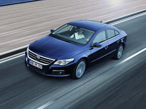 Majestic Volkswagen Passat Cc Gliding On An Open Road Wallpaper