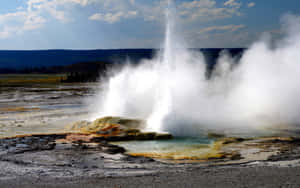 Majestic Yellowstone Geyser Erupting In Nature Wallpaper