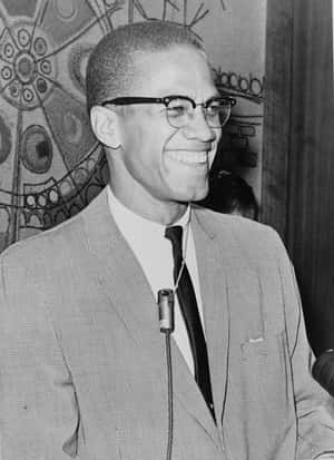 Malcolm X Smiling Blackand White Portrait Wallpaper