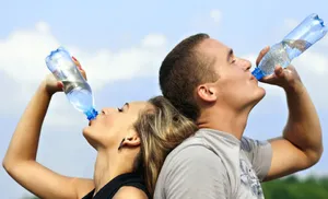 Man And Woman Drinking Water From Bottles Wallpaper