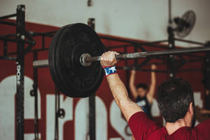 Man At Gym Weightlifting Wallpaper