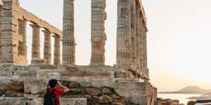 Man At The Temple Of Poseidon Wallpaper