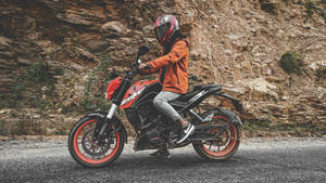 Man Driving A Ktm Duke 200 Wallpaper