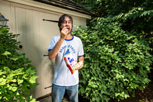 Man Eating Chips Outside Wallpaper