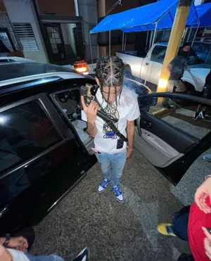 Man Exiting Car Nighttime Street Scene Wallpaper