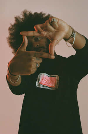 Man Framing Camera Gesture Pink Backdrop Wallpaper