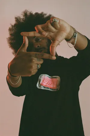 Man Framing Camera Gesture Pink Backdrop Wallpaper