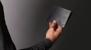 Man Holding Black Leather Wallet Wallpaper