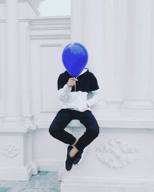 Man Holding Blue Balloon Wallpaper