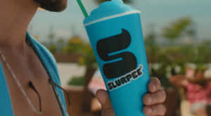 Man Holding Blue Slurpee Cup Wallpaper