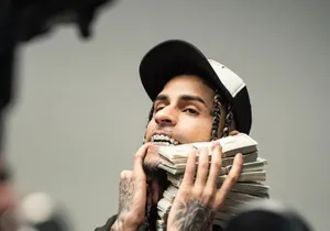 Man Holding Cash Stacks Wallpaper