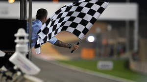 Man Holding Checkered Flag Wallpaper