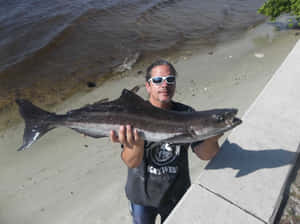 Man Holding Cobia Fish Wallpaper