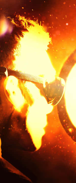 Man Illuminatedby Intense Fire Wallpaper