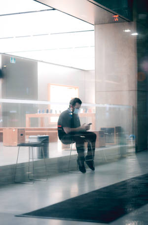 Man In Chair Simple Phone Wallpaper