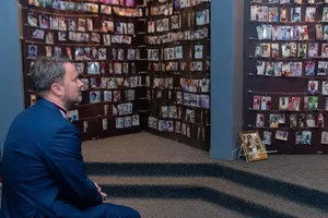 Man In Suit At Kigali Genocide Memorial Wallpaper