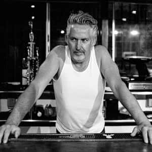 Man Leaningon Piano B W Wallpaper