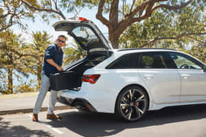 Man Loading Luggageinto White Car Wallpaper