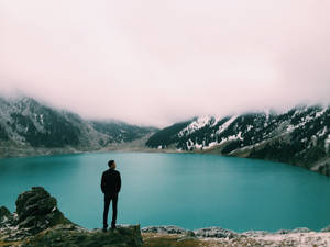 Man Looking At Big Almaty Lake Wallpaper