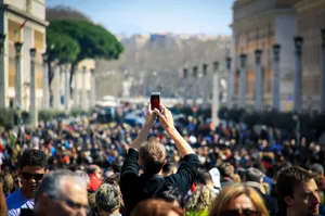 Man Looking Conspicuous With His Arms Raised For A Photo Wallpaper