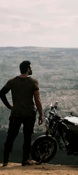 Man_ Motorcycle_ Cliff_ View.jpg Wallpaper