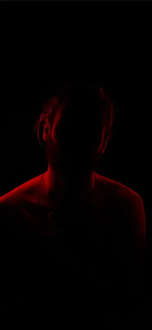 Man On A Somber Night With Red Light Wallpaper