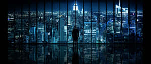 Man Overlooking Night Cityscape Wallpaper