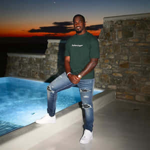 Man Posingby Poolat Sunset Wallpaper