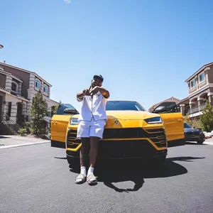 Man Posingin Frontof Yellow S U V Wallpaper