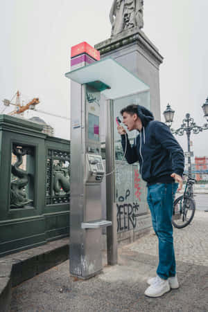 Man Shouting Into Payphone Wallpaper