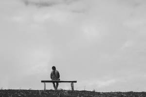 Man Sitting On Bench Wallpaper