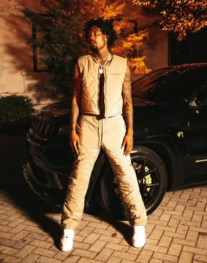 Man Standing Beside Black Car At Night.jpg Wallpaper