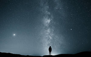 Man Stargazing Alone Wallpaper