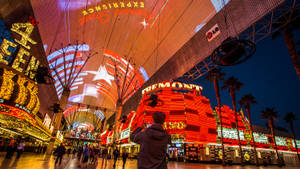 Man Taking Pictures Fremont Street Wallpaper