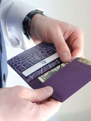 Man Using Purple Wallet Wallpaper