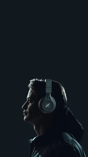Man Wearing A Wireless Peripheral Headphones Wallpaper