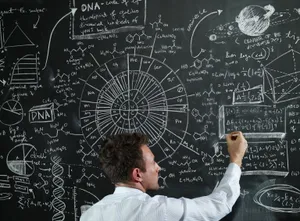 Man Writing Scientific Formulason Blackboard Wallpaper