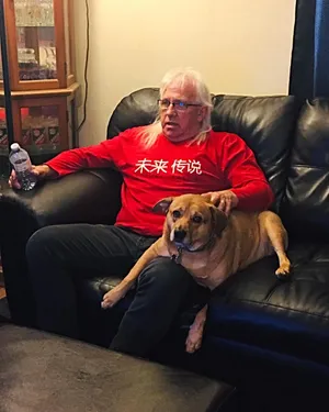 Manand Dog Relaxingon Couch Wallpaper