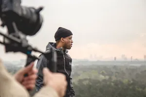 Manin Beanie Looking Away During Filming Wallpaper