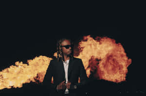 Manin Black Suitwith Fire Background Wallpaper