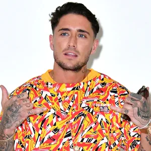 Manin Colorful Shirt Posing Wallpaper