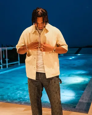 Manin Designer Clothesby Poolside Night Wallpaper