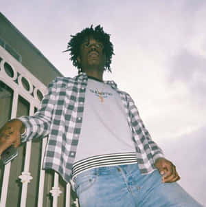 Manin Plaid Jacketand Jeans Outdoors Wallpaper