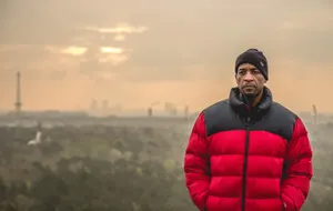 Manin Red Jacketwith City Skyline Wallpaper